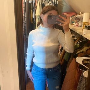 White turtleneck sweater.